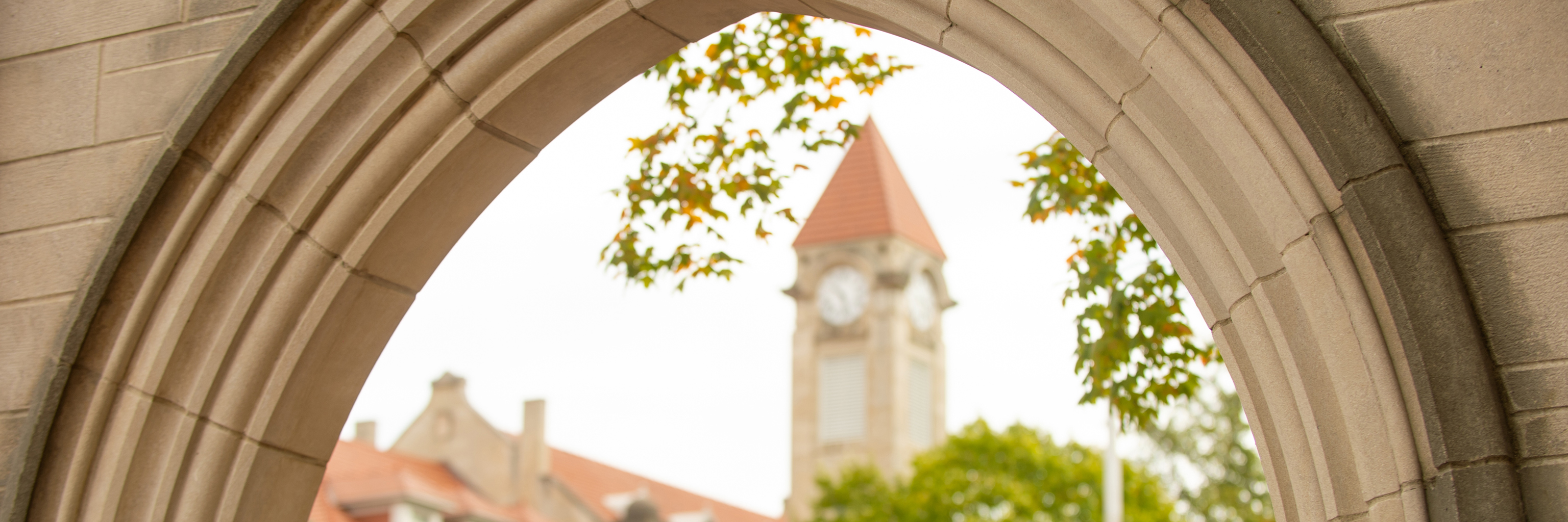 A view of the Student Building bell tower through the IU Sample Gates.
